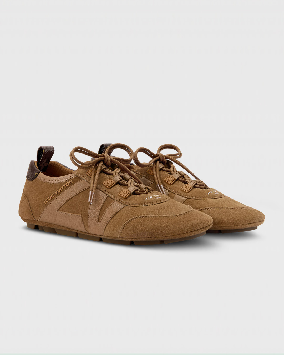 Brown Louis Vuitton suede sneakers with lace-up design and luxury branding details