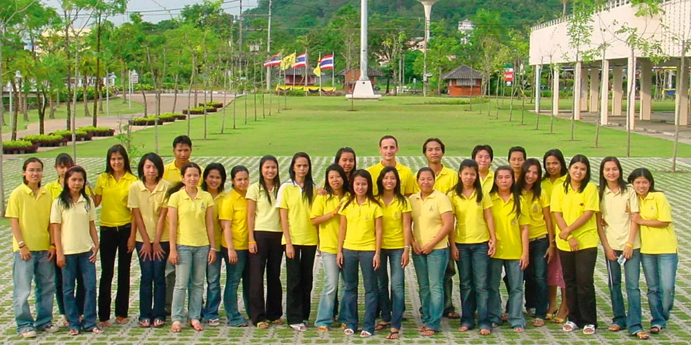 CLX team members standing outdoors in yellow shirts, representing employees at a company location.