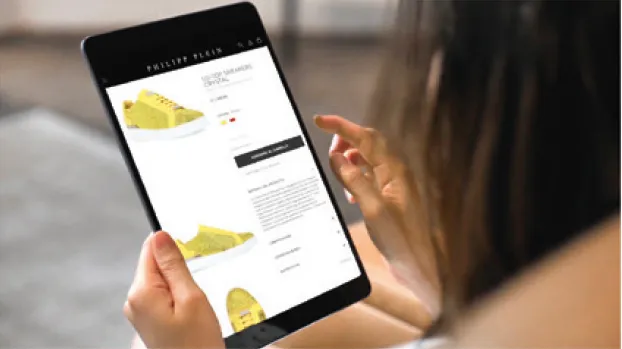 Customer browsing products on a tablet, representing CLX's expansion into eCommerce and digital retail solutions in 2010