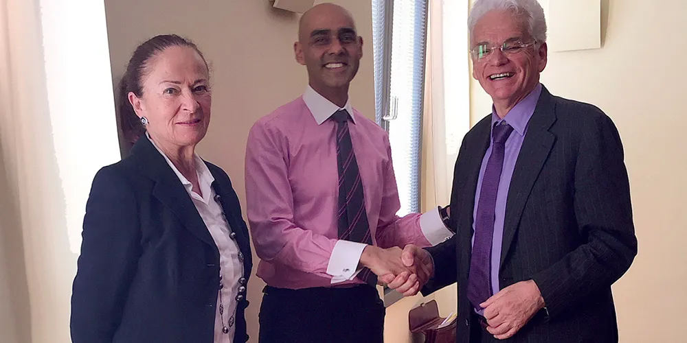 CLX executives shaking hands during the acquisition by eClerx in 2015, marking the start of global growth opportunities.