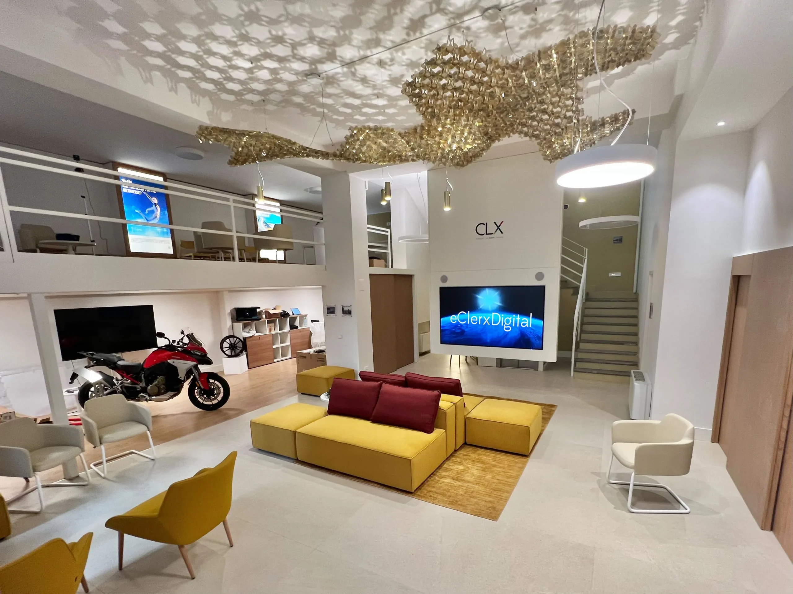 Interior view of CLX’s new technology hub in Milan, featuring digital displays, workspaces, and innovation-focused setup.