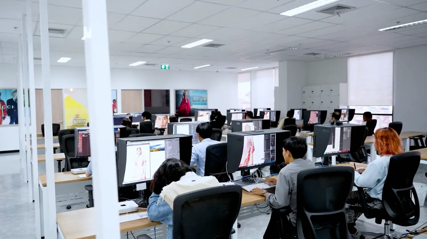 Employees working at computer stations in CLX’s Bangkok production site, supporting creative and digital production services.