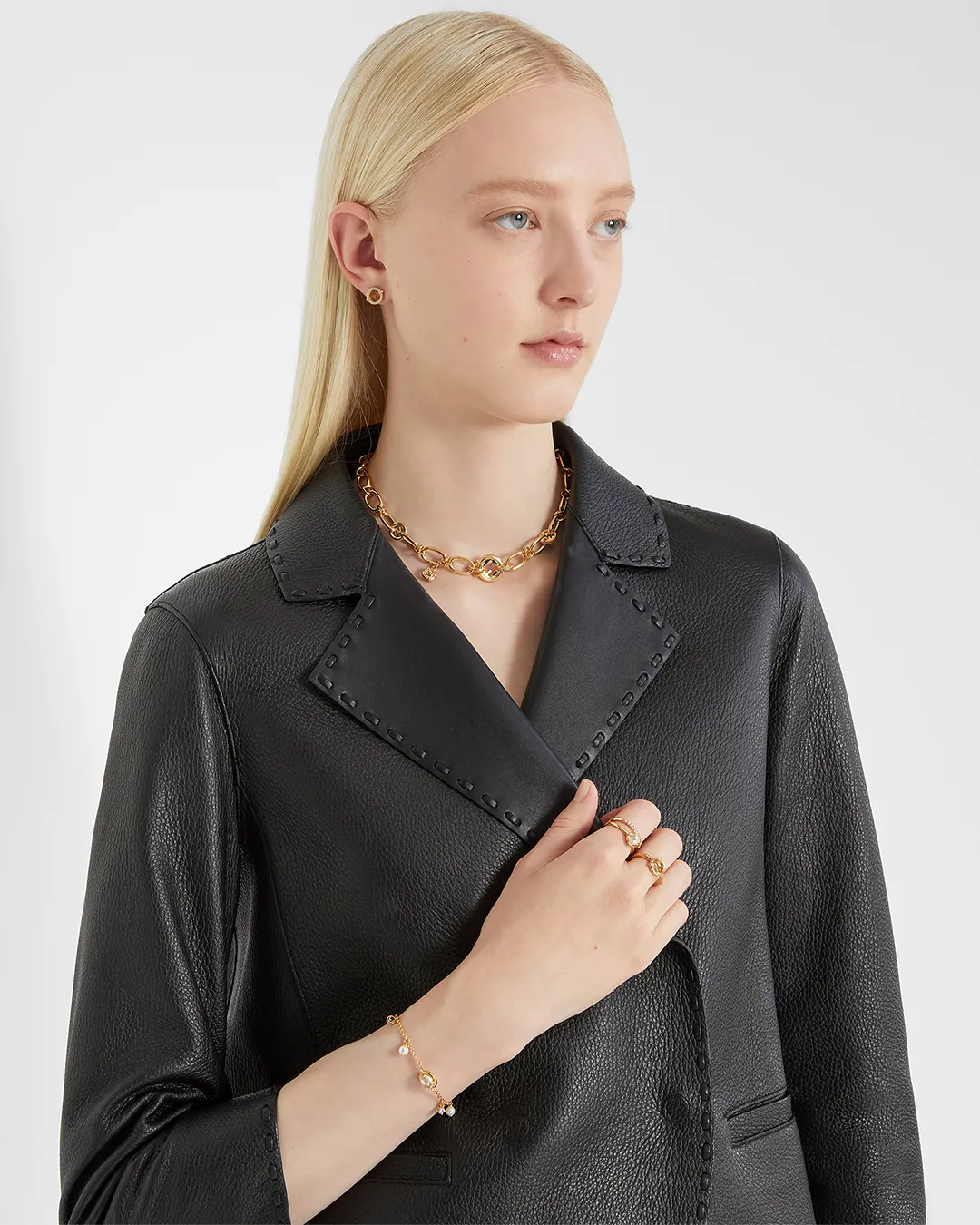Model wearing Fendi necklace, bracelet, and rings in portfolio image