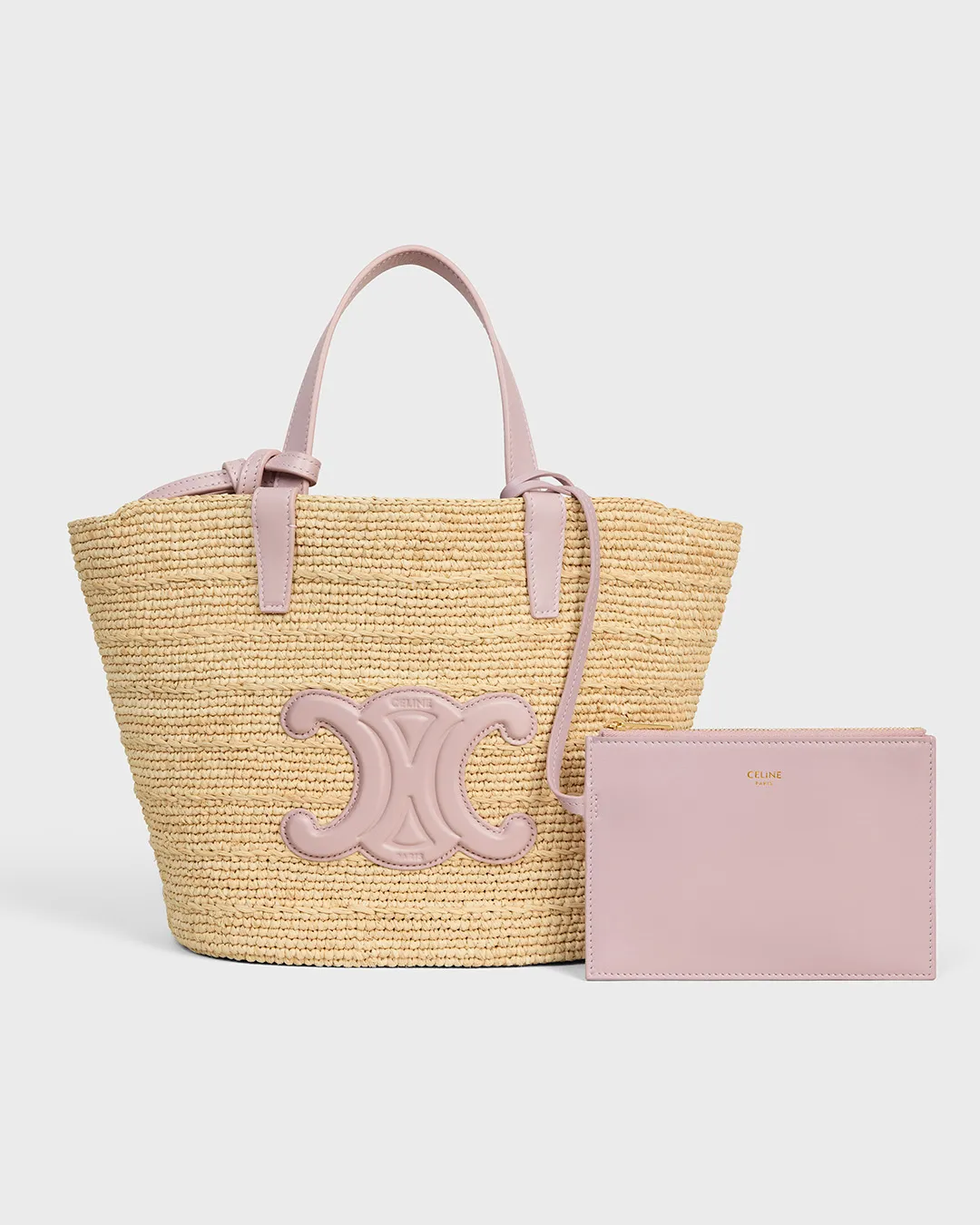Celine straw tote bag with pink leather handles and pouch displayed in portfolio image