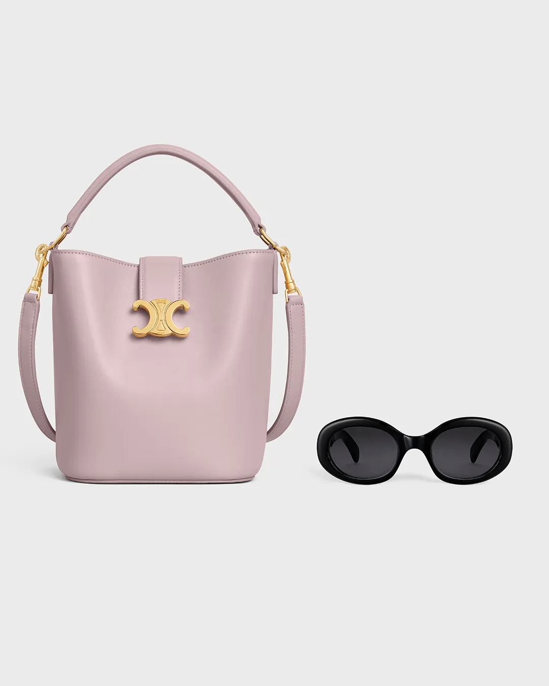 Celine pink leather bucket bag with gold logo and black sunglasses displayed in portfolio image