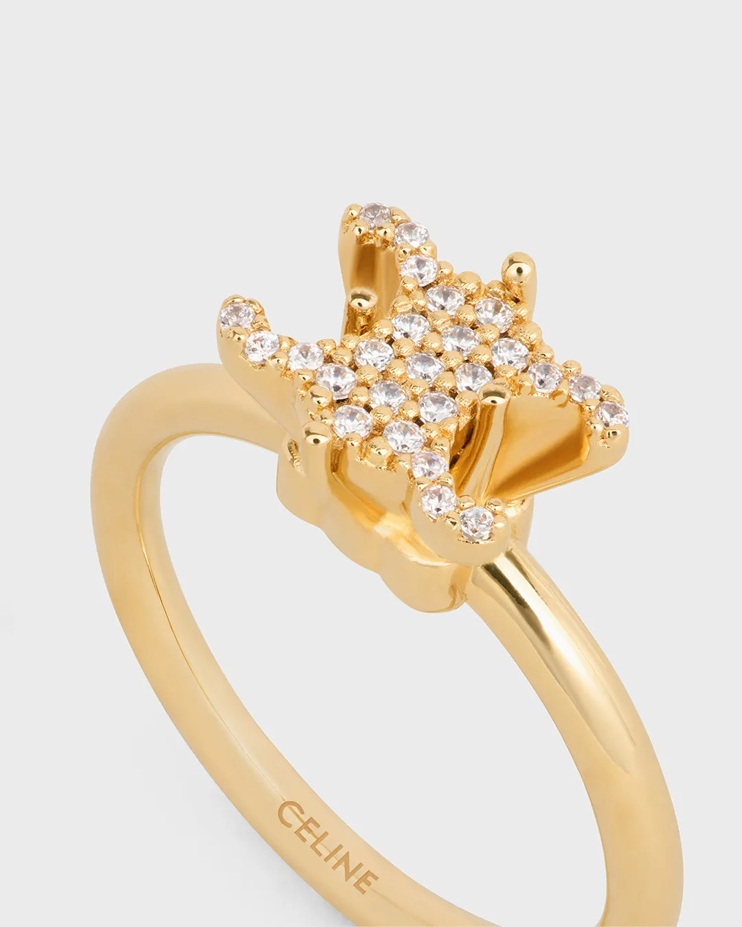 Celine gold ring with diamond-studded design displayed in portfolio image
