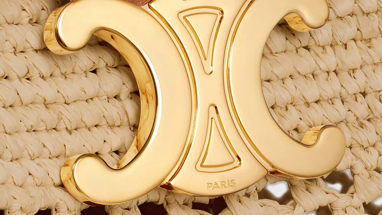 Celine gold logo detail on woven raffia handbag displayed in portfolio image