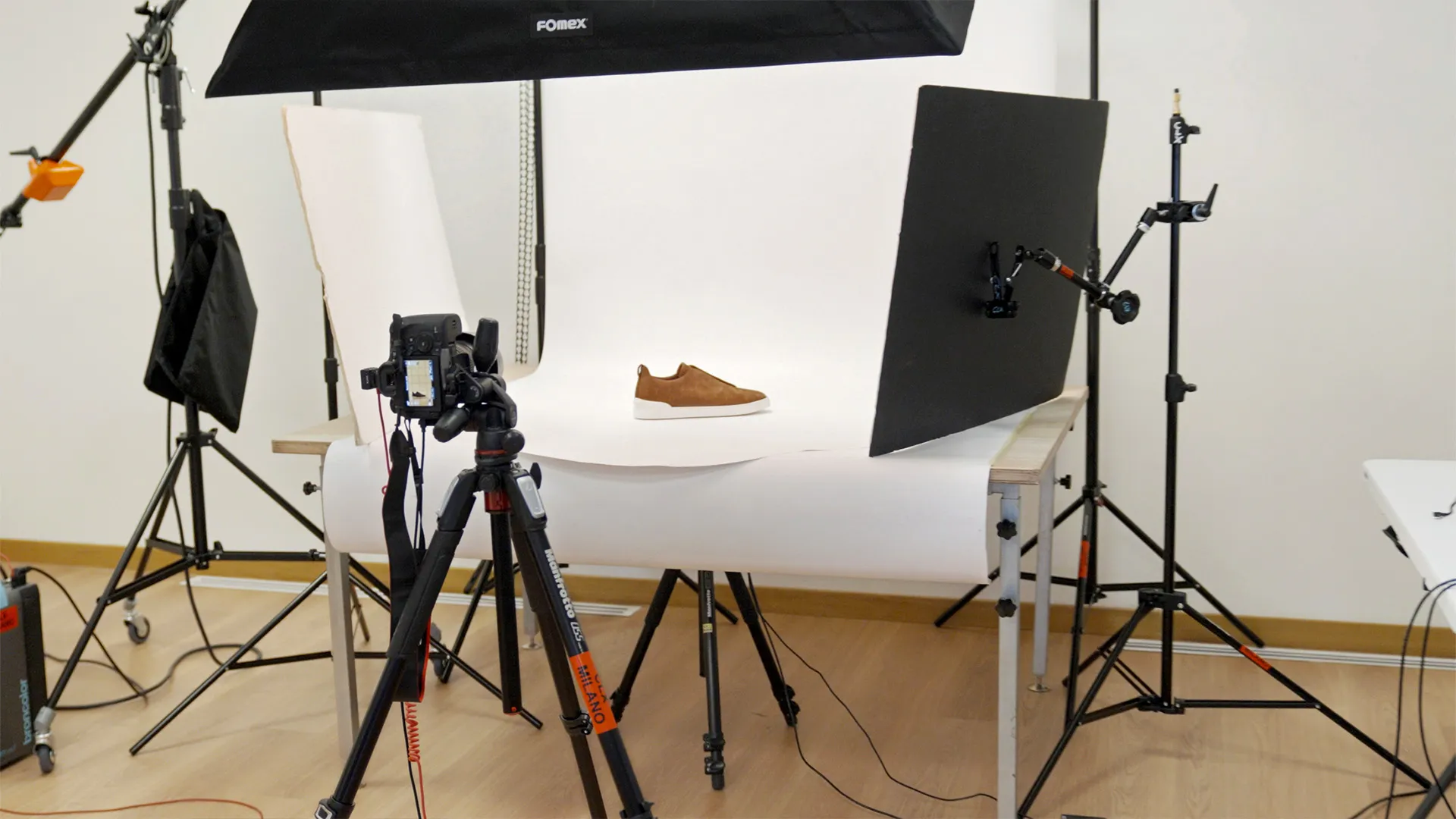 CLX Milano photo studio setup for product photography with professional camera, lighting equipment, and backdrop
